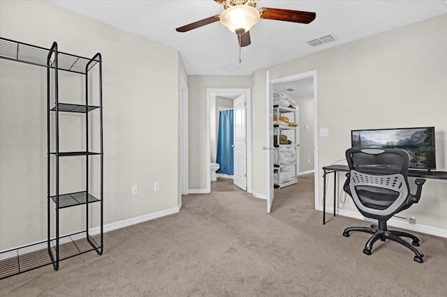 office featuring ceiling fan, carpet floors, visible vents, and baseboards
