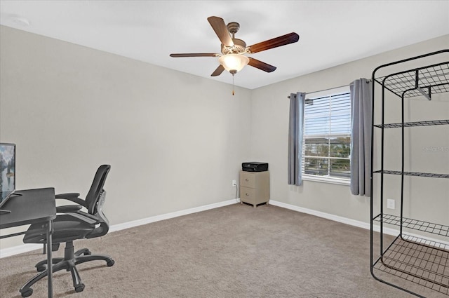unfurnished office with baseboards, carpet floors, and ceiling fan