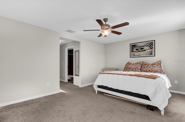 carpeted bedroom with visible vents, a ceiling fan, and baseboards