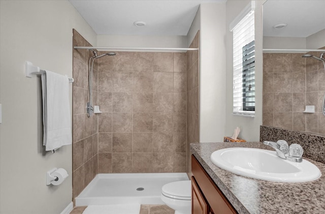full bathroom with vanity, a shower stall, and toilet