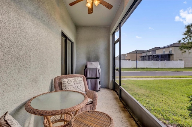 sunroom with a ceiling fan