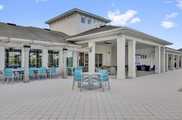 rear view of house featuring a ceiling fan, outdoor lounge area, a pergola, outdoor dining space, and stucco siding