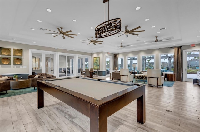 playroom with a ceiling fan, pool table, light wood-type flooring, a tray ceiling, and recessed lighting