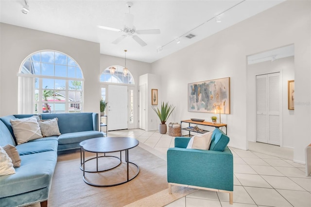 living room featuring light tile patterned floors, a ceiling fan, visible vents, and track lighting