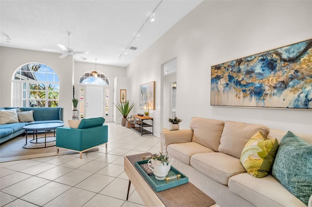 living room with light tile patterned flooring, visible vents, and track lighting