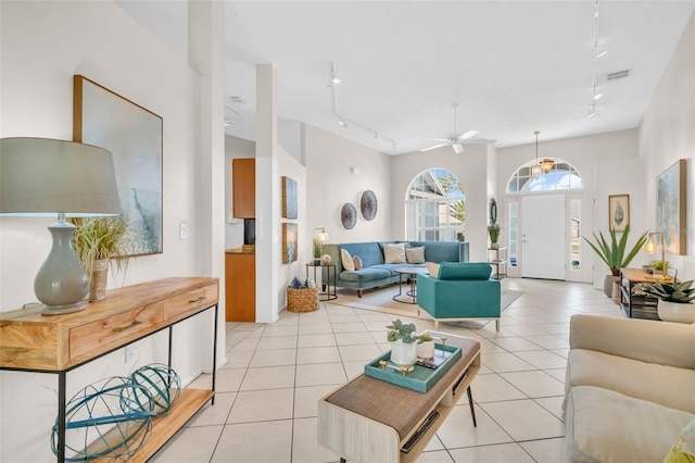 living area featuring light tile patterned floors, ceiling fan, rail lighting, and visible vents