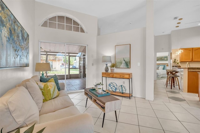 living room with light tile patterned floors and a towering ceiling