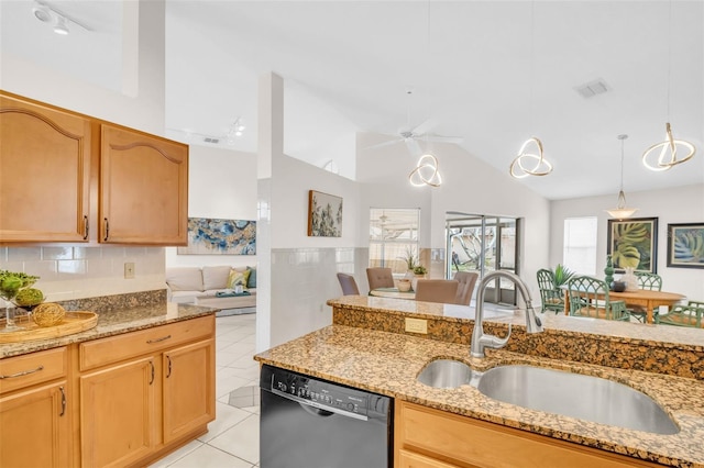 kitchen featuring pendant lighting, black dishwasher, light tile patterned floors, a sink, and light stone countertops