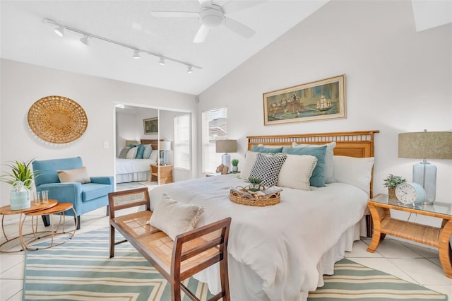 bedroom featuring a ceiling fan, vaulted ceiling, and light tile patterned floors