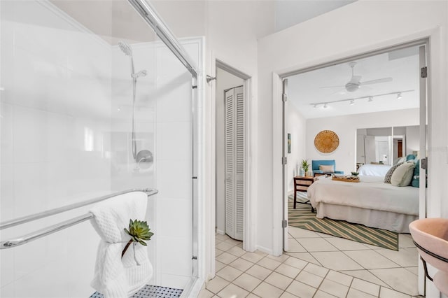 ensuite bathroom featuring a shower stall, a closet, a ceiling fan, and connected bathroom