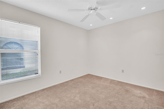 carpeted spare room featuring baseboards, a ceiling fan, and recessed lighting