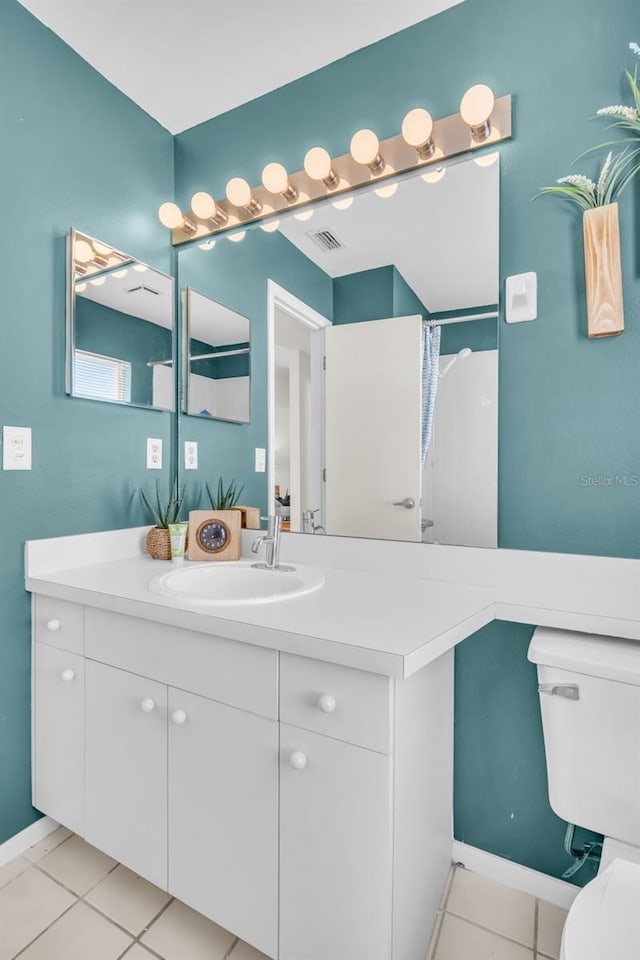 full bath with visible vents, vanity, toilet, and tile patterned floors