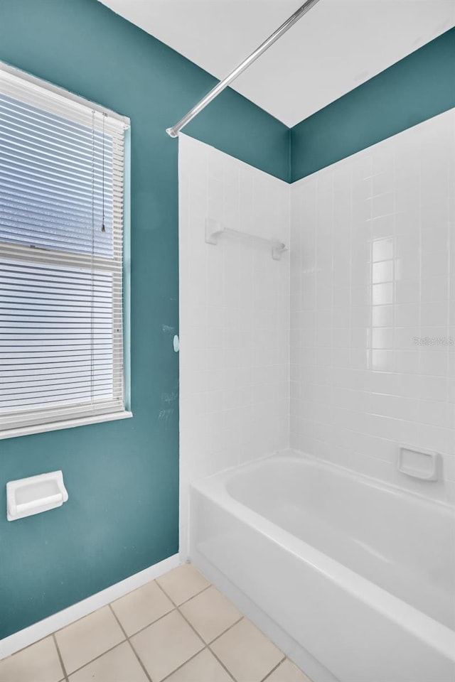 bathroom featuring tile patterned flooring, baseboards, and shower / bathing tub combination