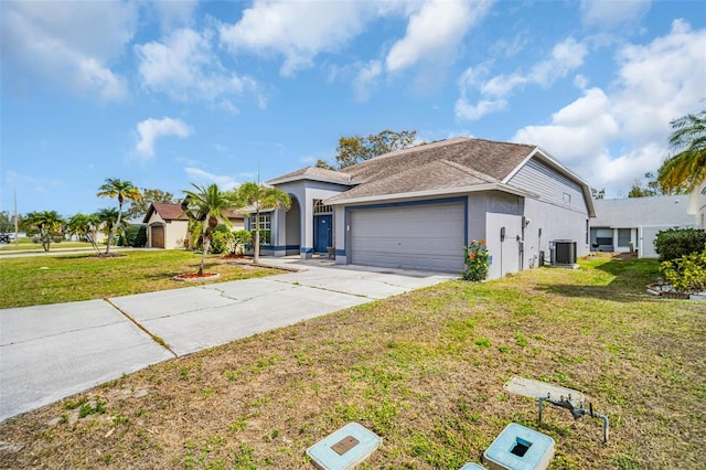 view of front of property featuring central AC unit, an attached garage, concrete driveway, stucco siding, and a front yard