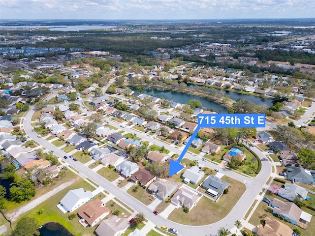 bird's eye view with a residential view and a water view