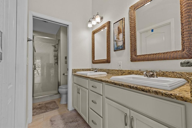 full bath featuring a sink, a shower stall, and toilet