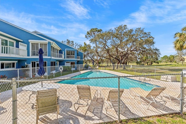 pool featuring a patio area and fence