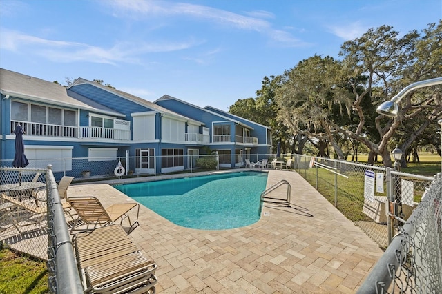 pool featuring a patio and fence