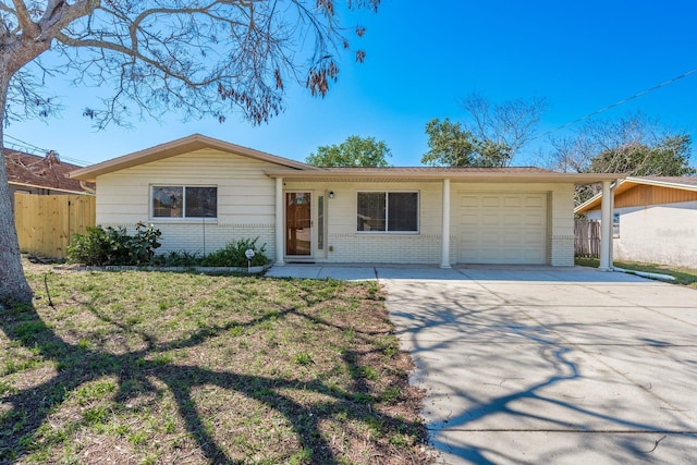 ranch-style house with concrete driveway, brick siding, an attached garage, and fence