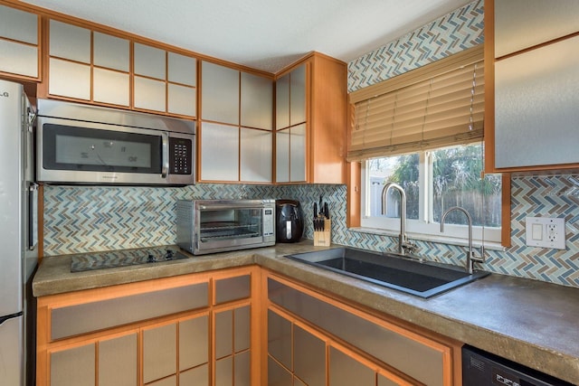 kitchen featuring black appliances, backsplash, a sink, and a toaster