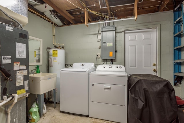 washroom featuring laundry area, electric panel, heating unit, water heater, and separate washer and dryer