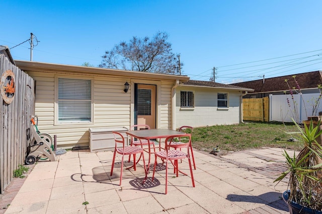 view of patio / terrace featuring outdoor dining area and fence