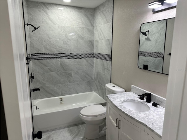 bathroom with a textured wall, toilet,  shower combination, marble finish floor, and vanity
