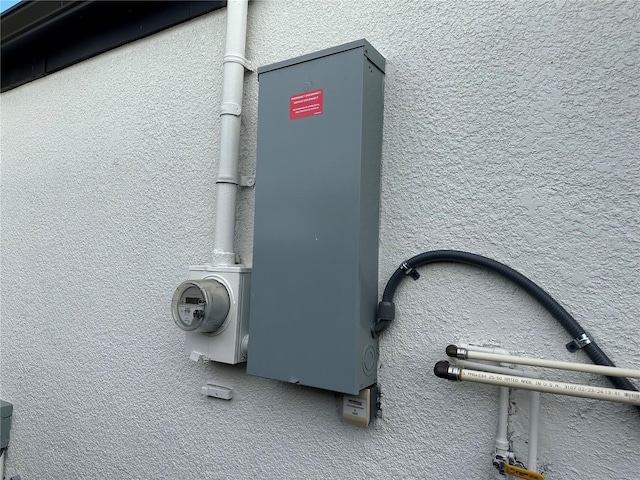 exterior details with electric meter and stucco siding