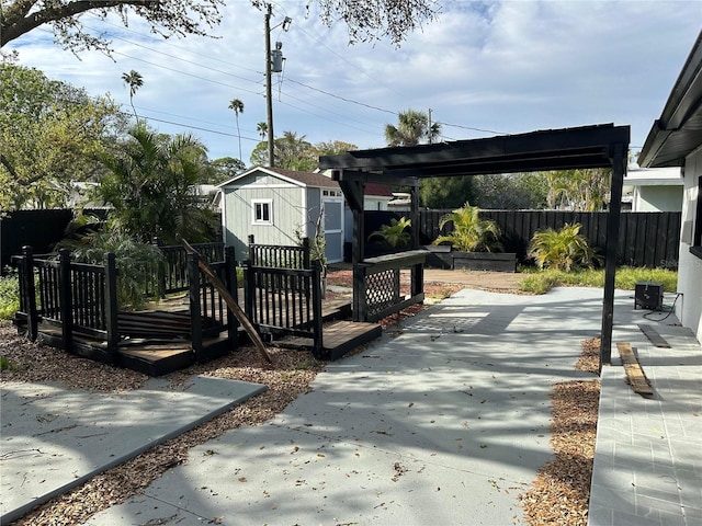 exterior space with a fenced backyard, an outdoor structure, and a shed