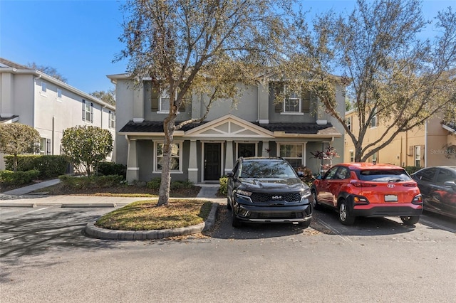 traditional-style home with uncovered parking and stucco siding