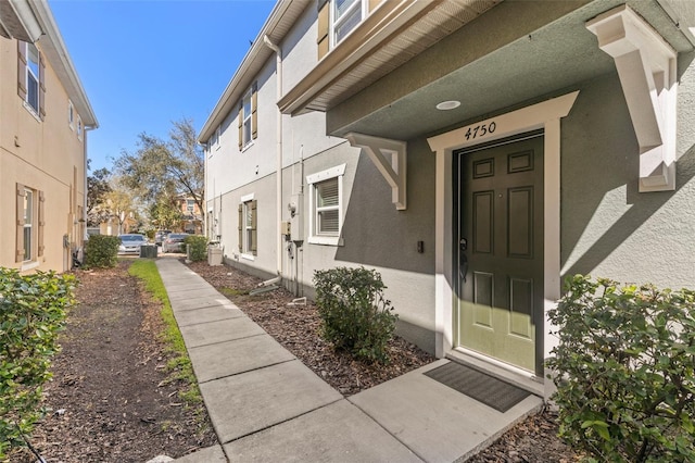 doorway to property featuring a residential view and stucco siding