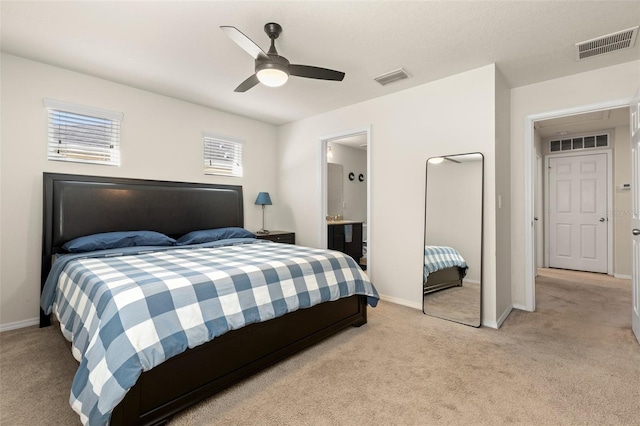 bedroom featuring visible vents and light colored carpet