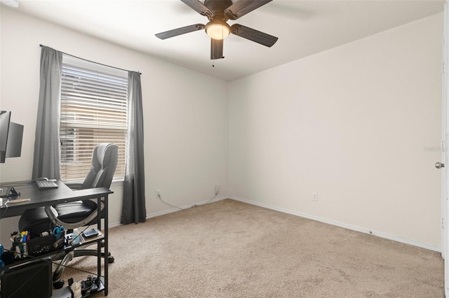 office with baseboards, a ceiling fan, and light colored carpet