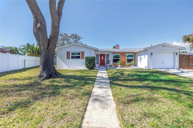 view of front facade with a garage, concrete driveway, fence, and a front lawn