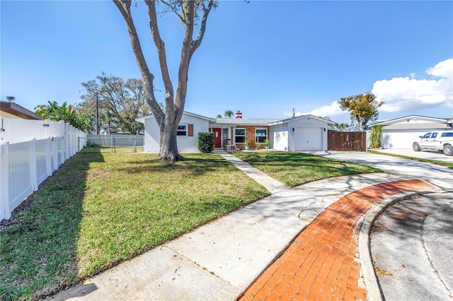 view of front of home with a garage, concrete driveway, fence, and a front lawn