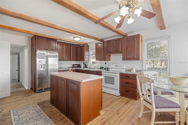 kitchen featuring light wood-style floors, stainless steel refrigerator with ice dispenser, electric stove, and light countertops