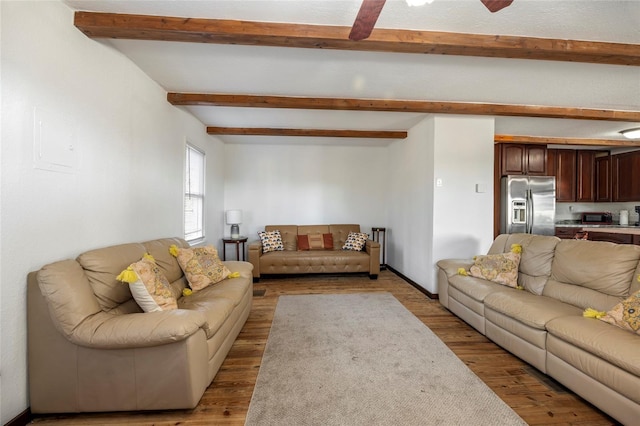 living room with beam ceiling, baseboards, and wood finished floors