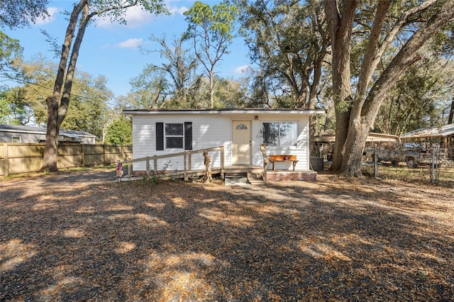 rear view of house with fence