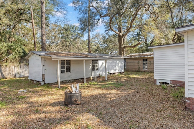 exterior space with fence and an outbuilding