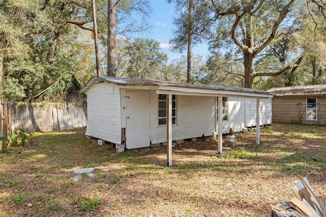 view of outdoor structure with an outbuilding and fence