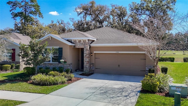 ranch-style house featuring a garage, stone siding, concrete driveway, and stucco siding