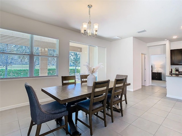 dining space featuring baseboards, visible vents, an inviting chandelier, and light tile patterned floors