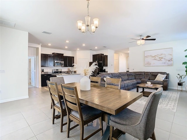 dining room featuring recessed lighting, visible vents, light tile patterned flooring, baseboards, and ceiling fan with notable chandelier