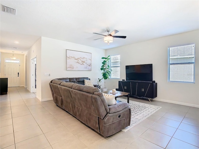 living room featuring visible vents, baseboards, and light tile patterned floors