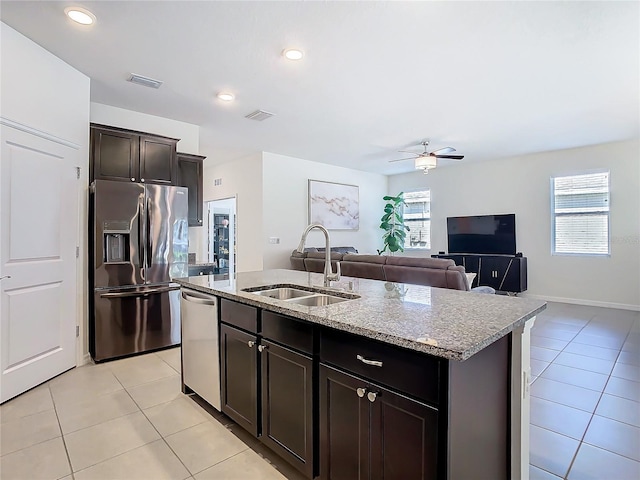 kitchen with visible vents, stainless steel appliances, a sink, and light tile patterned flooring