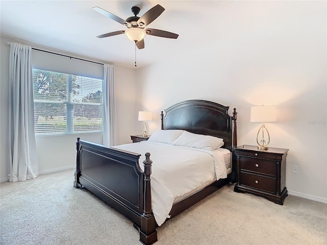 bedroom with baseboards, a ceiling fan, and light colored carpet