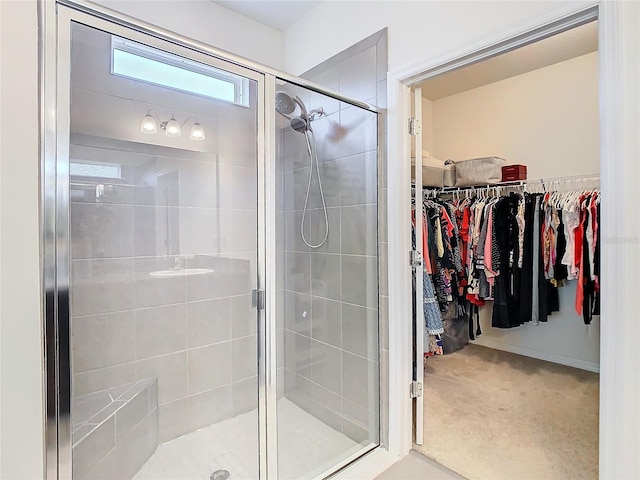 full bathroom featuring a stall shower and a walk in closet