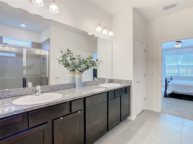 ensuite bathroom featuring visible vents, a sink, a shower stall, and ceiling fan