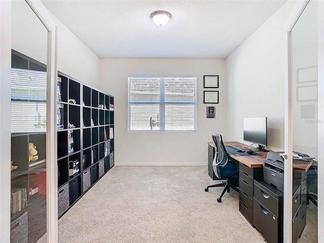 carpeted office featuring baseboards