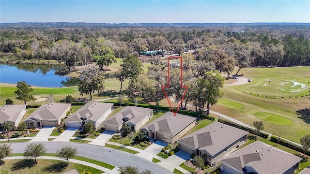 aerial view featuring a residential view, a water view, a view of trees, and golf course view